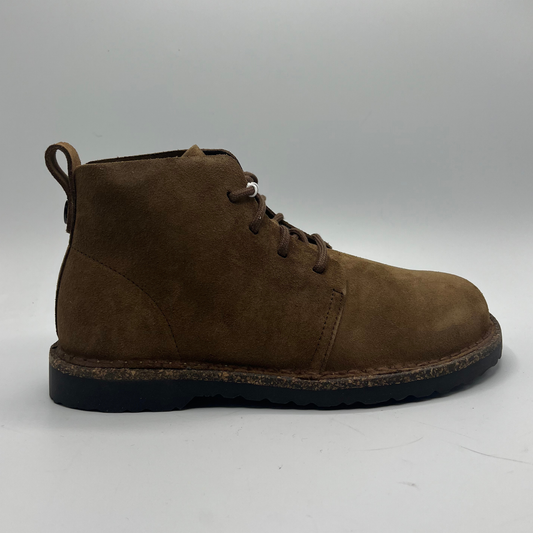 Brown suede boot on a white background