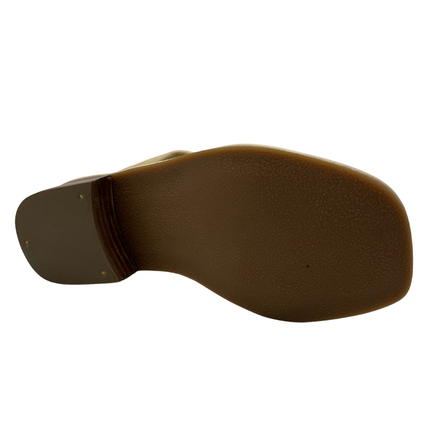Bottom view of cream leather sandal with short block heel and large knot detail on straps.