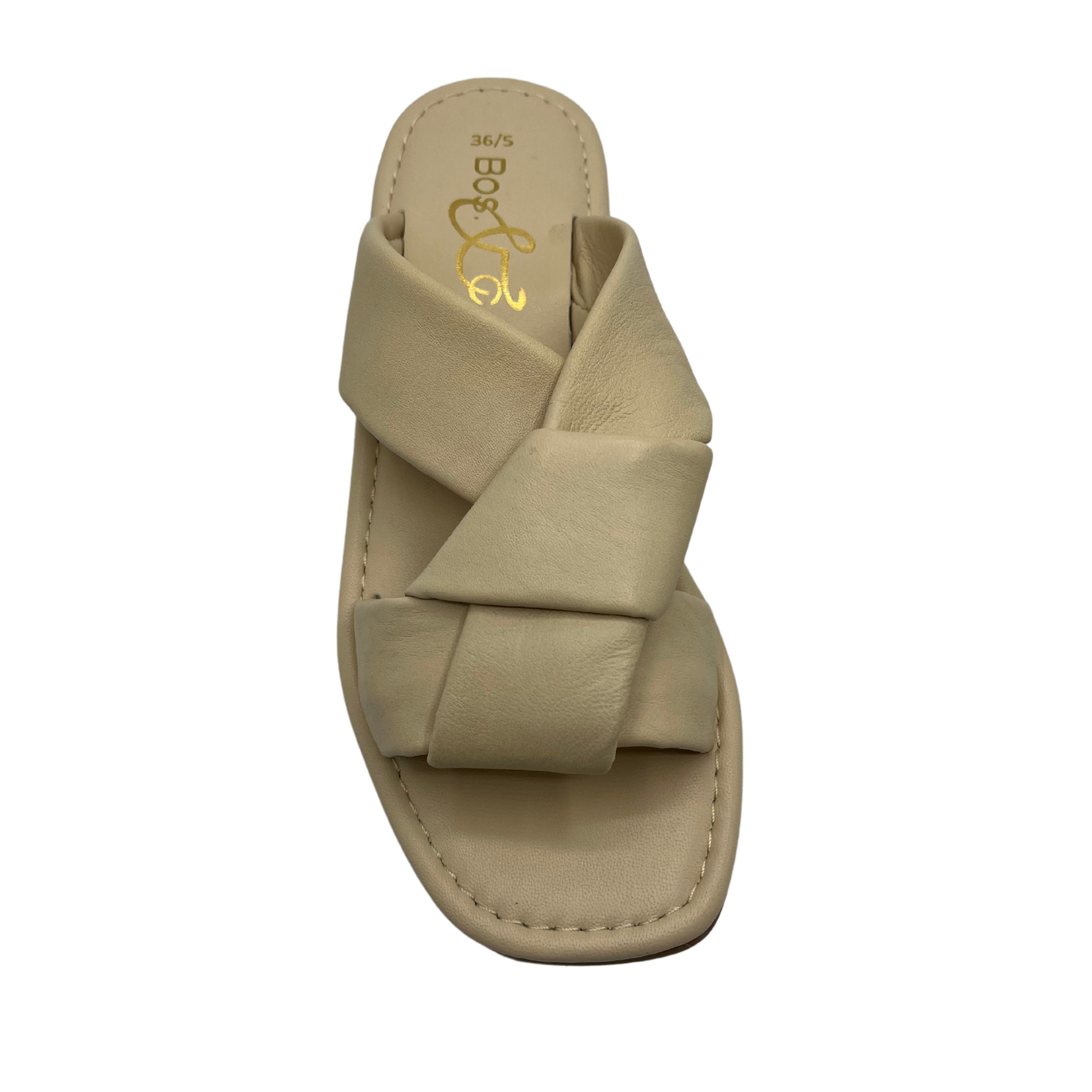 Top view of cream leather sandal with short block heel and large knot detail on straps.
