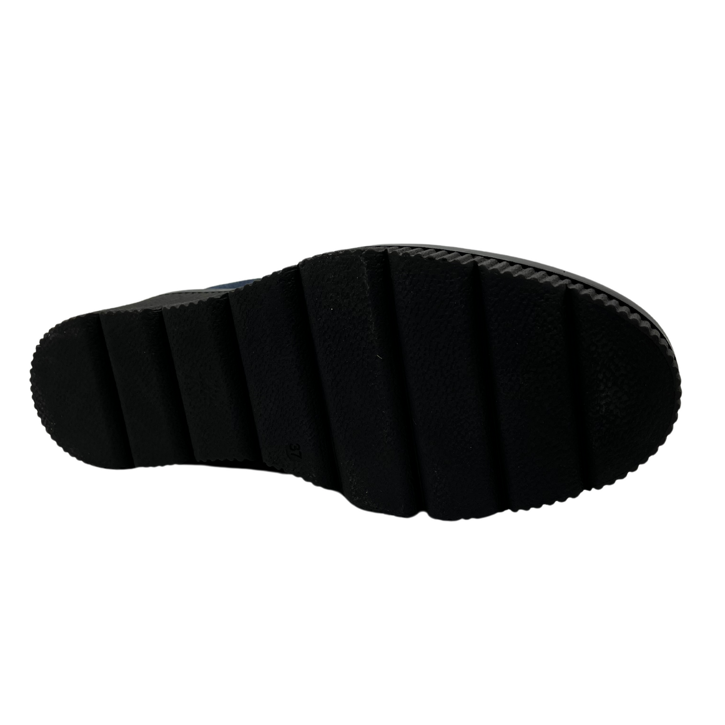 Bottom view of denim blue short bootie with slouched front, side zipper closure and black wedge heel.