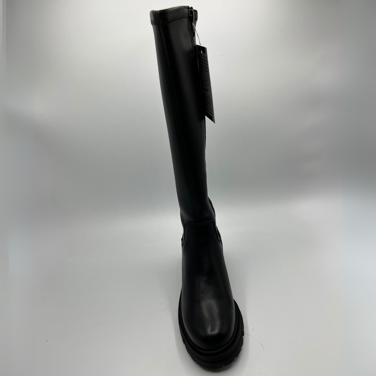 Black knee-high boot on a light gray background