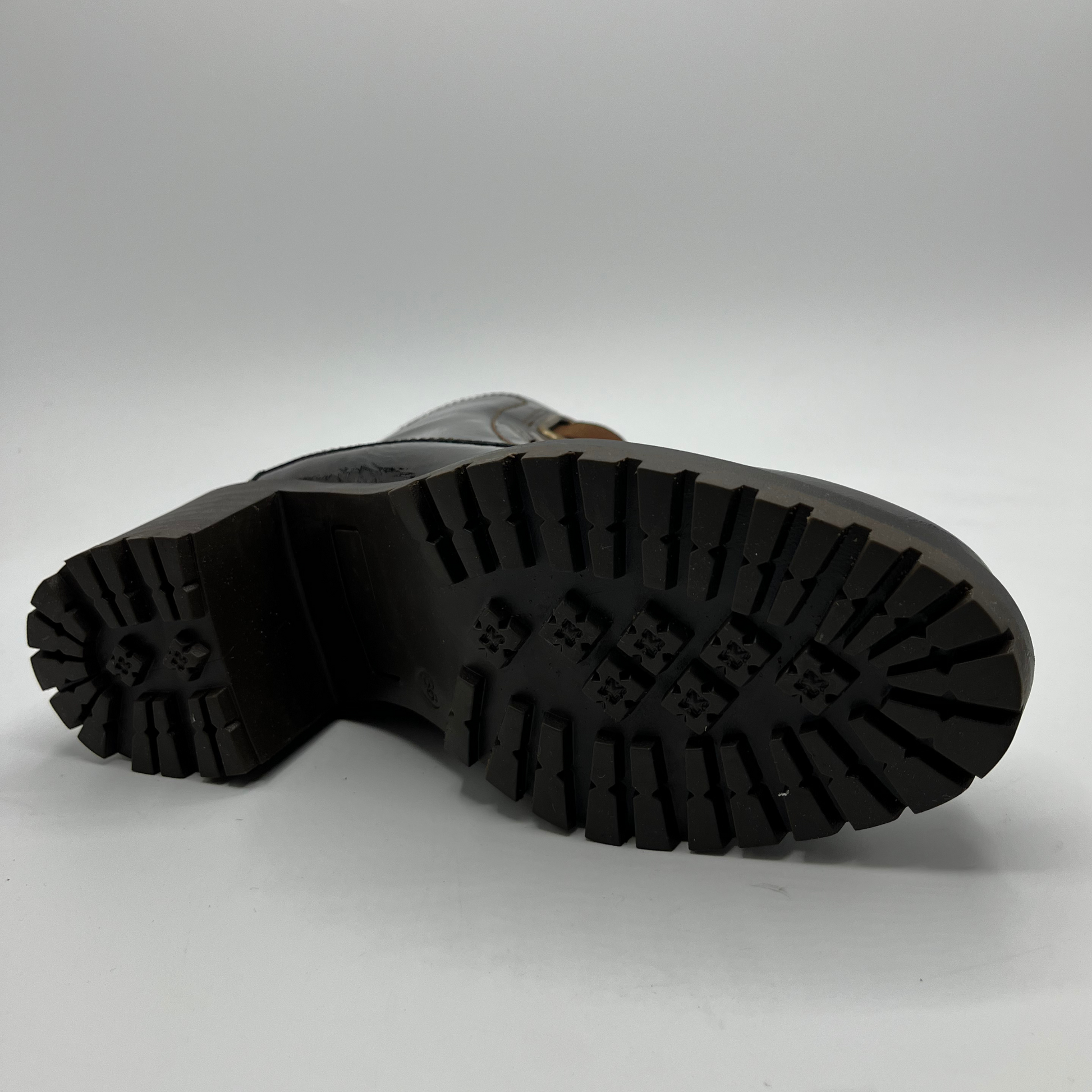 Close-up of a black boot sole on a white background