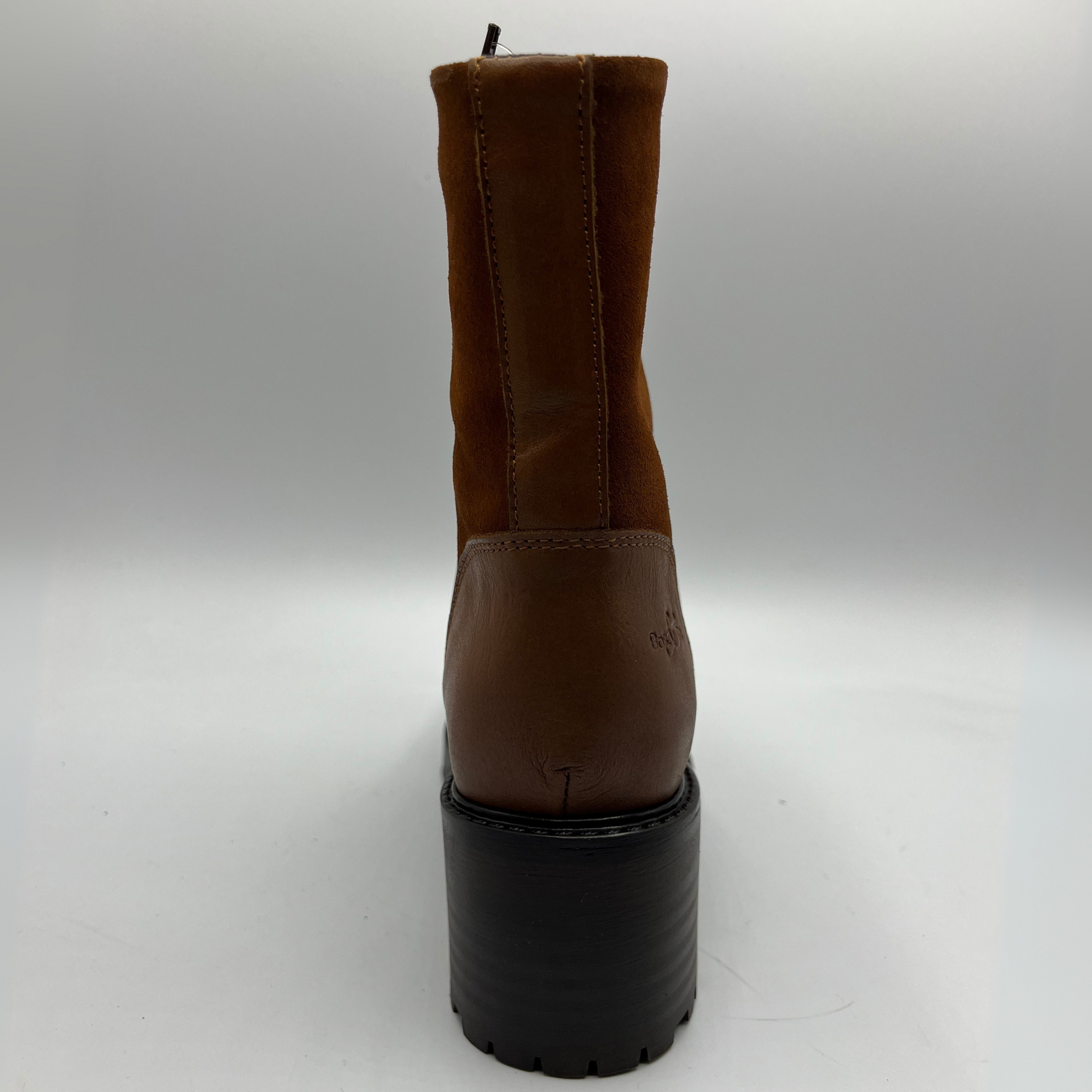 Red brown boot with a black sole on a white background