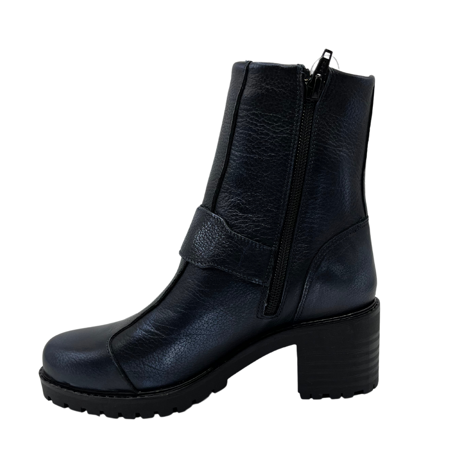 Left facing view of dark blue leather boot with chunky heel, mid height strap and off center zipper closure and side zipper closure