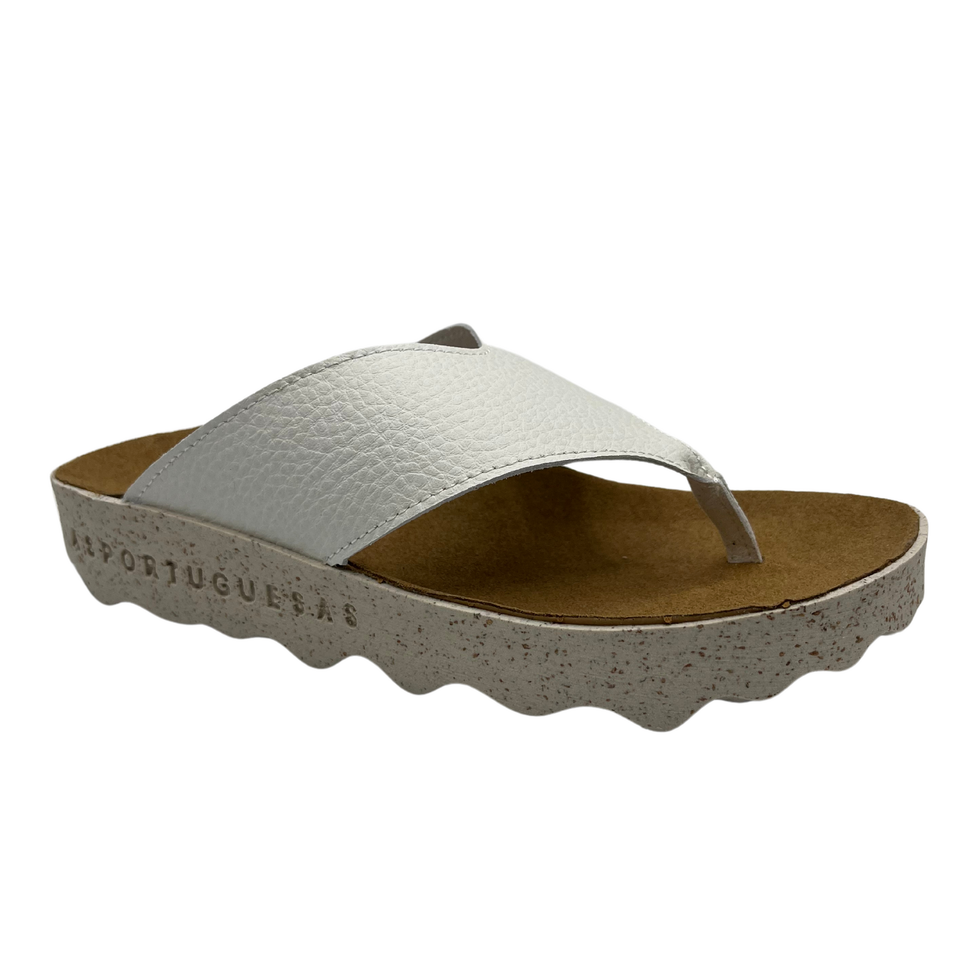 45 degree angled view of white strapped thong sandal with brown contoured footbed and white speckled outsole