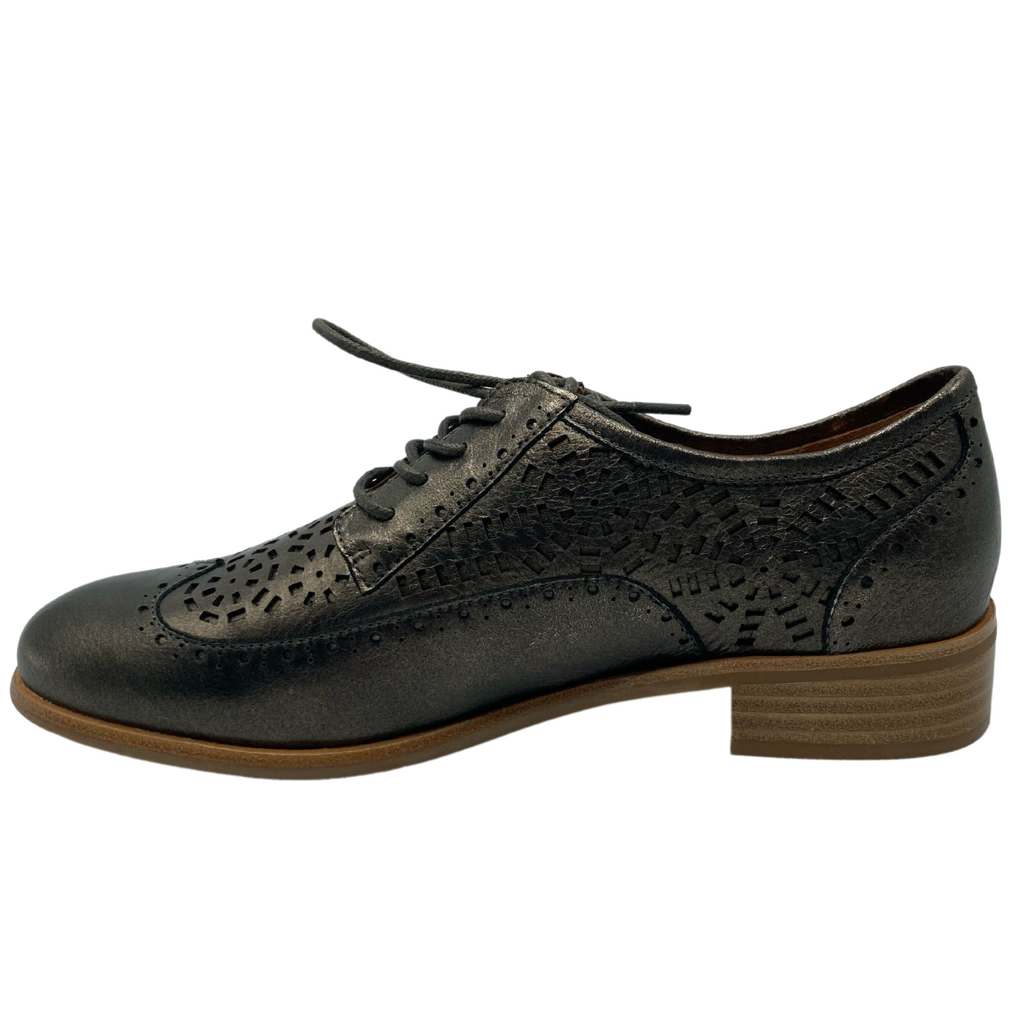 Left facing view of leather shoe with decorative cutouts and short brown heel and sole