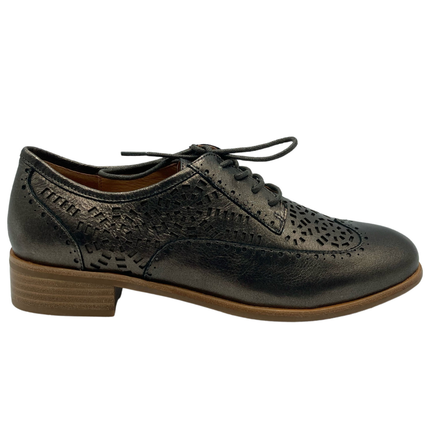 Right facing view of leather shoe with short brown heel and decorative cut outs around upper