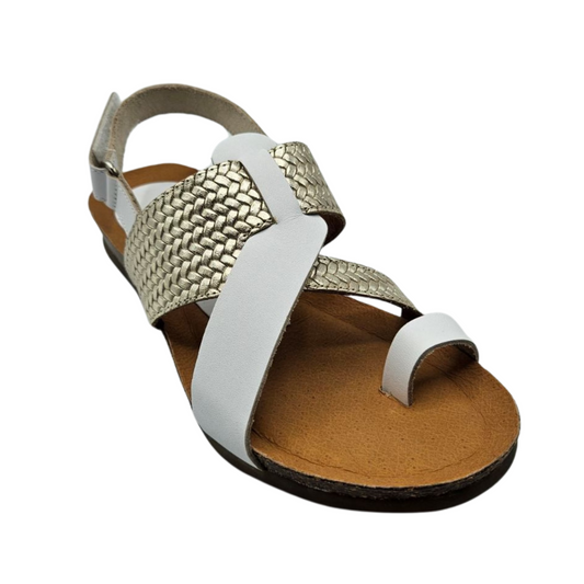 45 degree angled view of white and gold leather sandal with a toe strap and velcro ankle strap. Braided detail on the gold strap and cushioned footbed