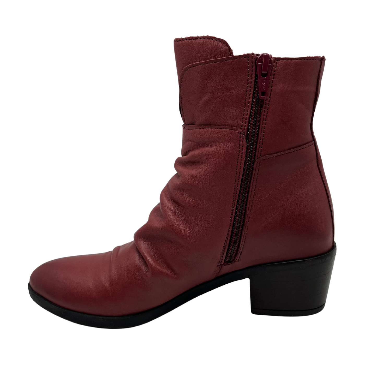 Left facing view of red leather short boot with a slouchy rouched upper, side zipper closure, 2 inch chunky heel and pointed toe