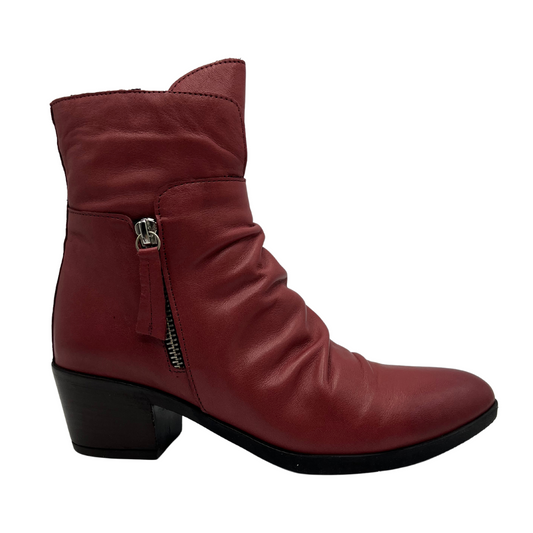 Right facing view of red leather short boot with a slouchy rouched upper, side zipper closure, 2 inch chunky heel and pointed toe