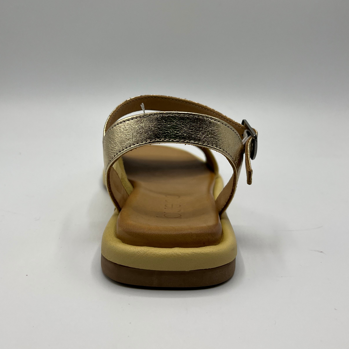 Back view of a leather sandal with a cushioned, leather lined insole and an adjustable ankle strap.