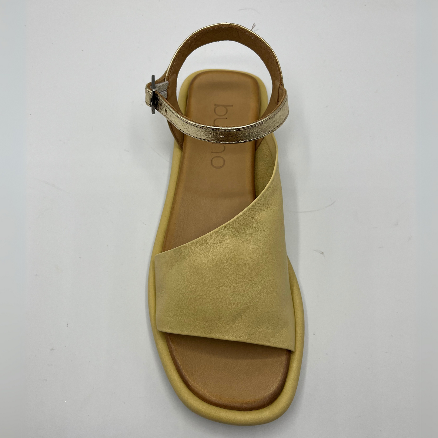 Top view of a leather sandal with a cushioned, leather lined insole and an adjustable ankle strap.