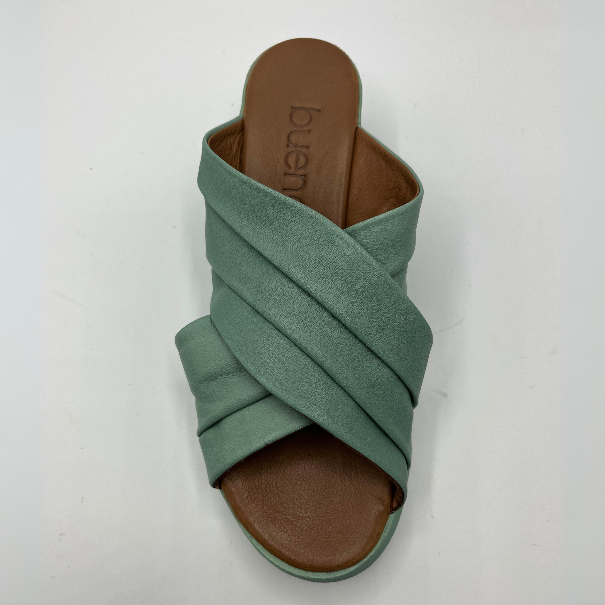 Top view of a leather slip on sandal in seafoam. Rouched cross strapped design and a wedge heel.