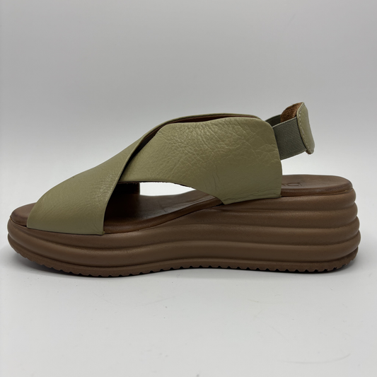 Green sandal with brown sole on a white background