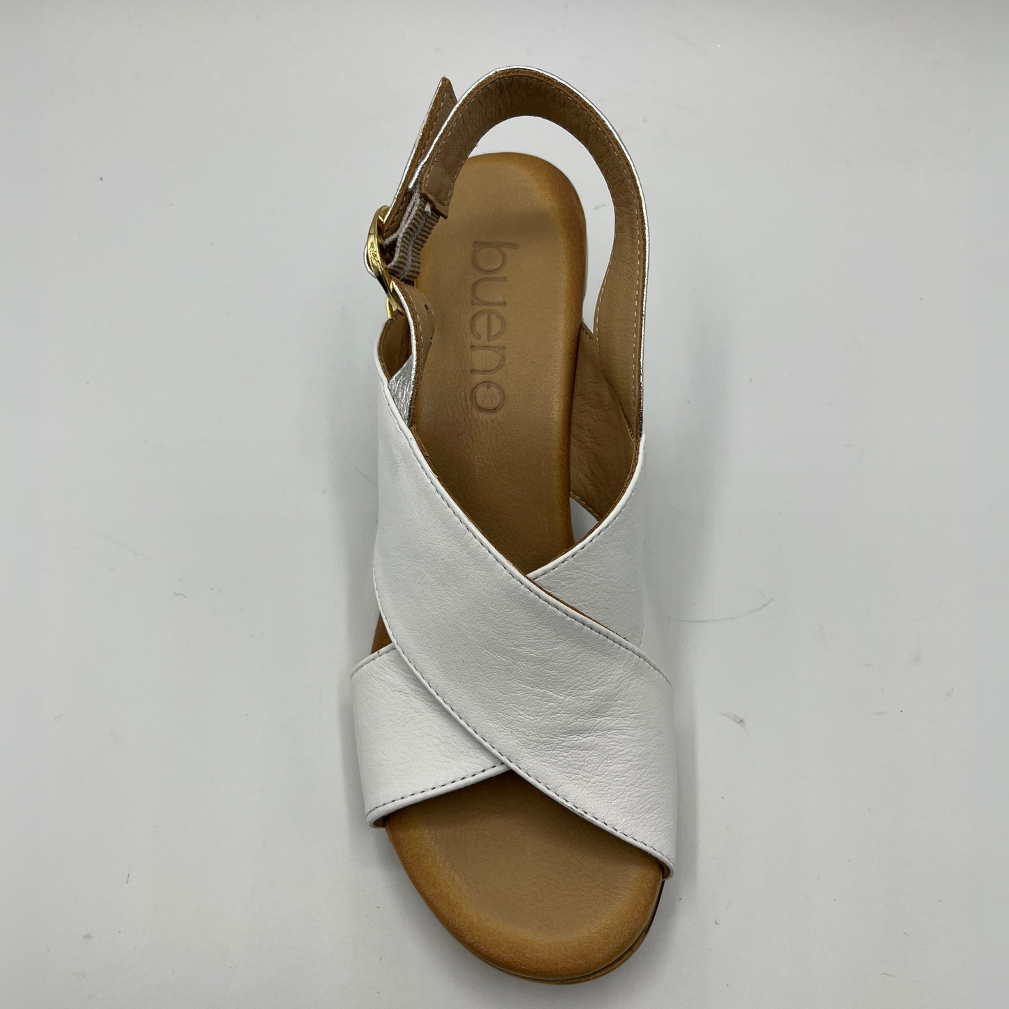 Top view of leather sandal with white straps. It has a block heel and a silver slingback strap