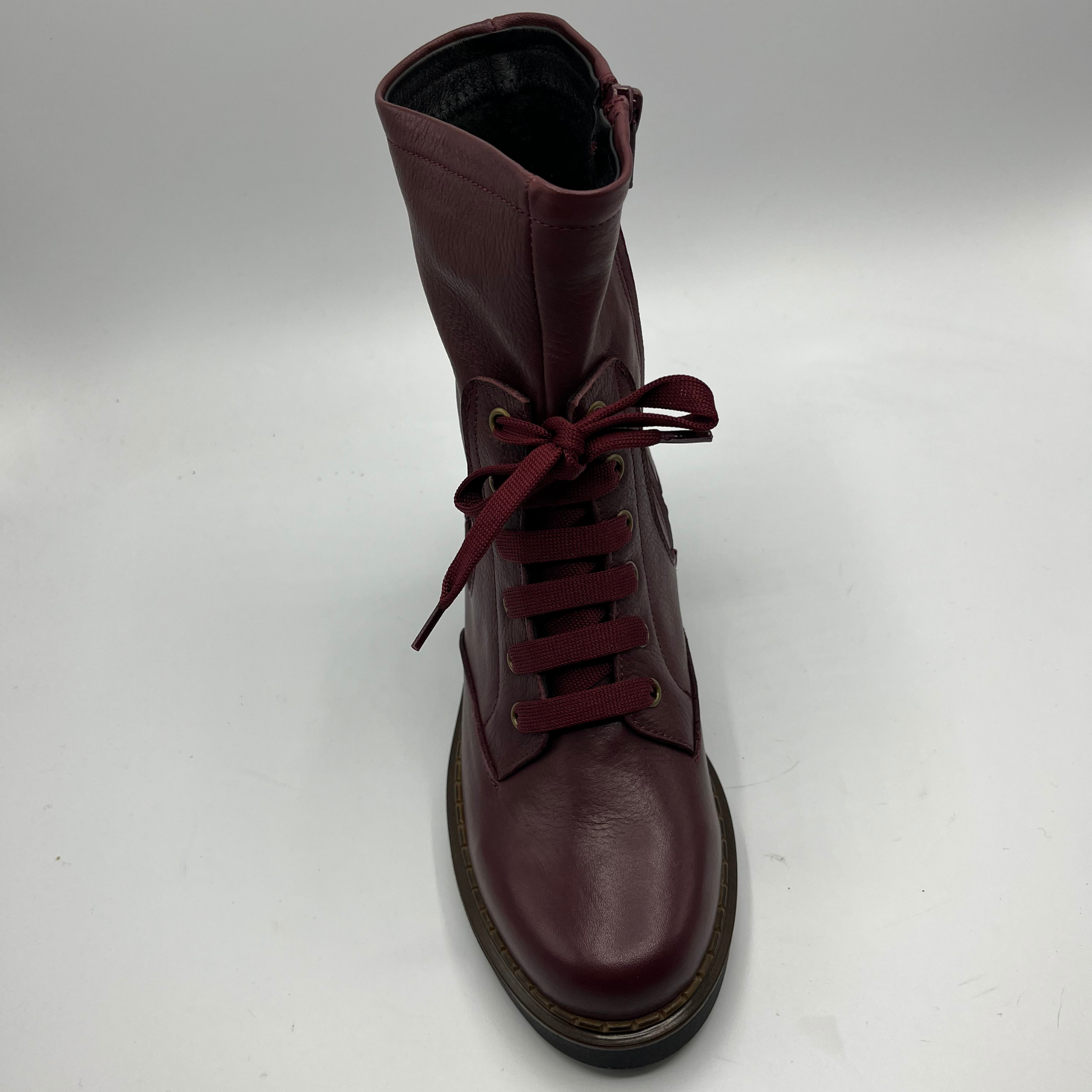 Merlot  leather boot with red laces on a white background