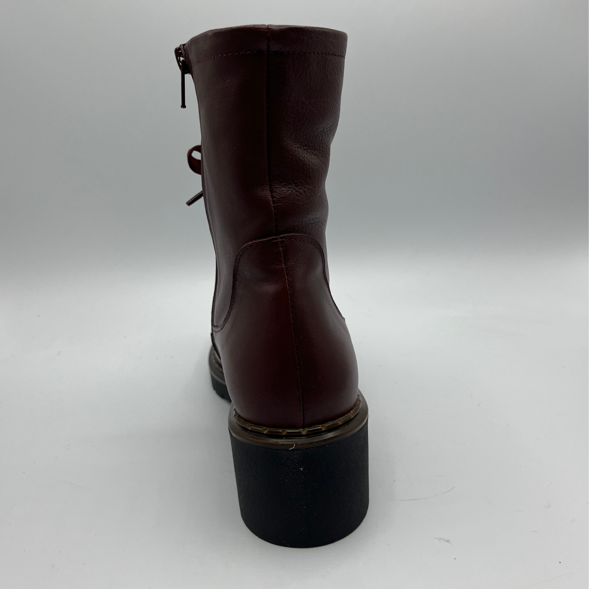 Merlot  leather boot with a black sole on a white background