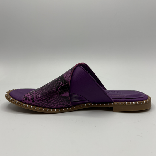 Purple sandal with a snake patterned strap on a gray background