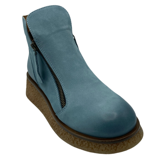 45 degree angled view of sky blue leather ankle boot with platform wedge sole and double zipper closure