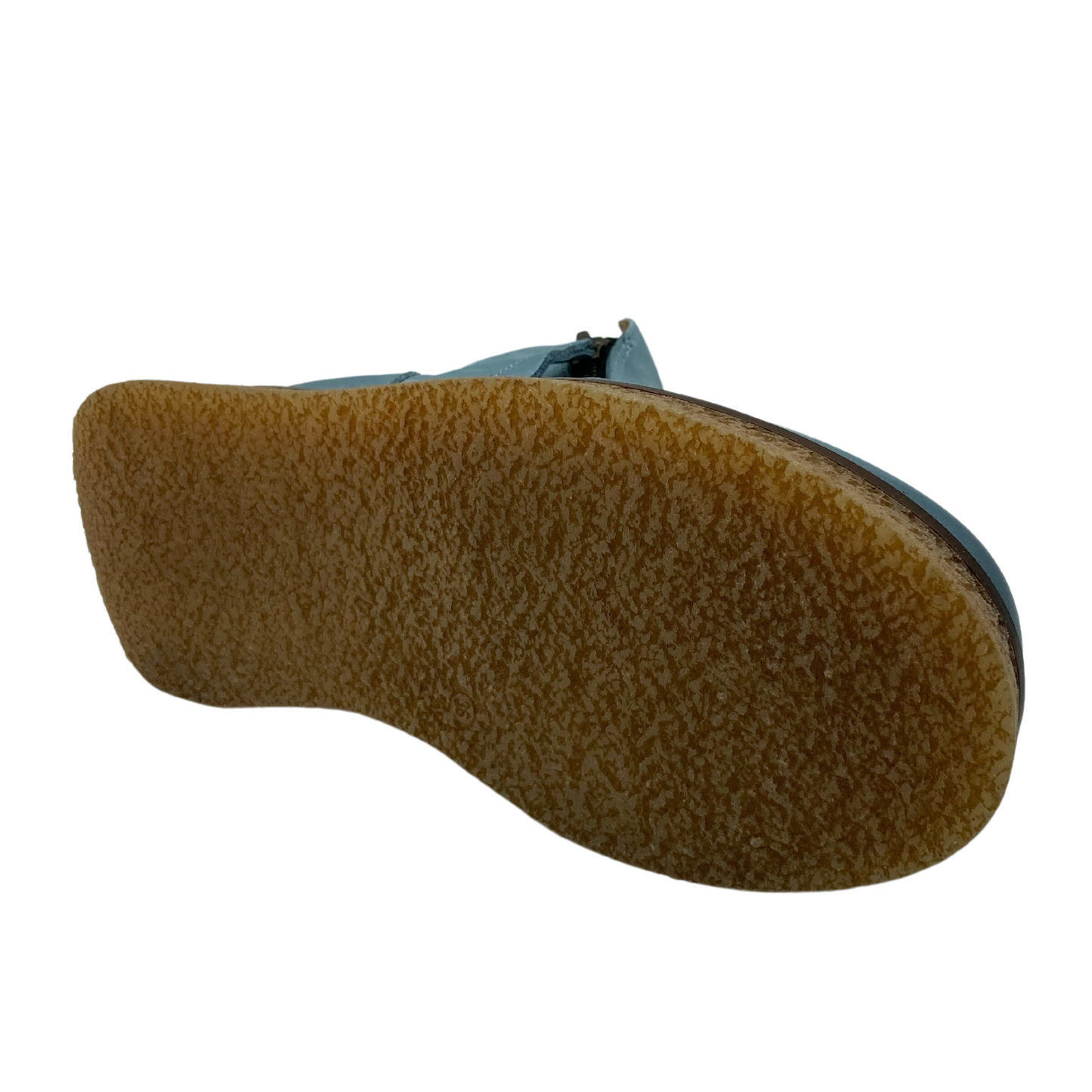 Bottom view of blue leather ankle boot with brown rubber platform outsole