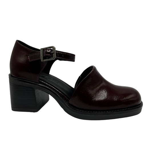 Right facing view of burgundy patent leather shoe with ankle strap, thick block heel and rounded toe.