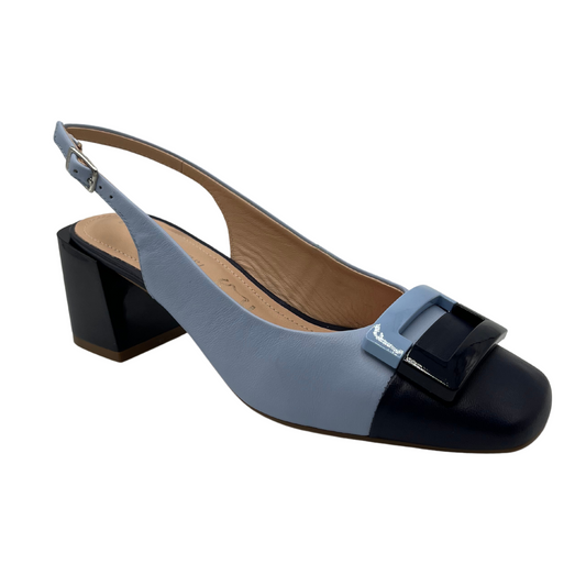 45 degree angled view of light blue and navy slingback heel with block heel and square detail on toe