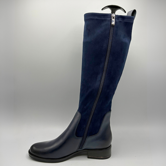 Left facing view of a tall navy boot with an inner zipper closure