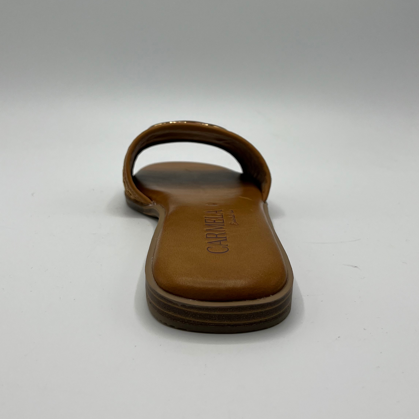 Back view of a flat leather lined sandal with a chain pattern on the strap as well as decorative branding.