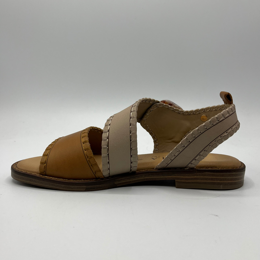 Left facing view of a leather sandal with a cushioned footbed and an adjustable strap with a tortoise shell buckle.