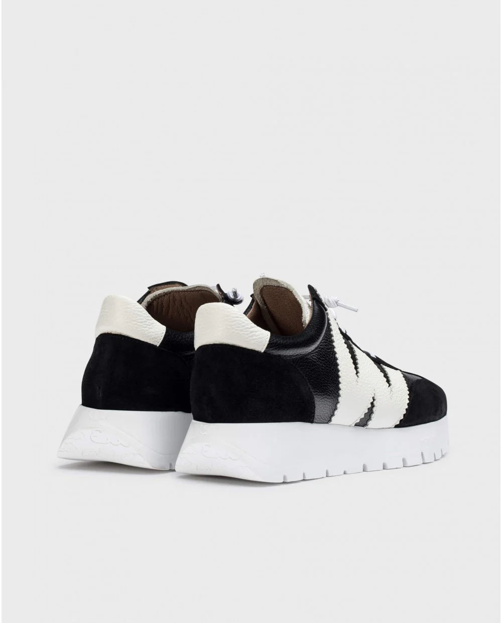 Black and white sneakers on a light gray background