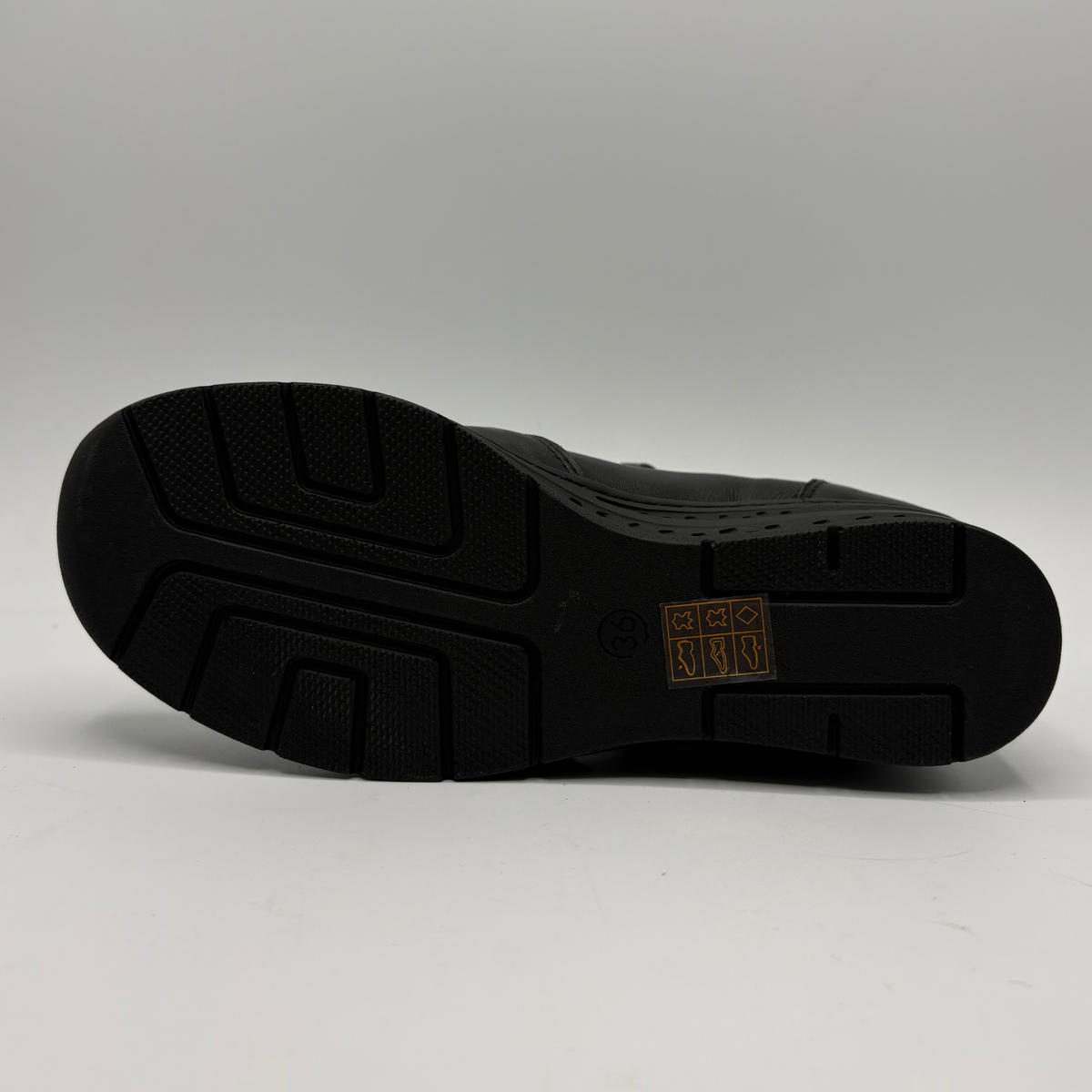 Bottom view of a black ankle boot with a side zipper closure and slight wedge sole
