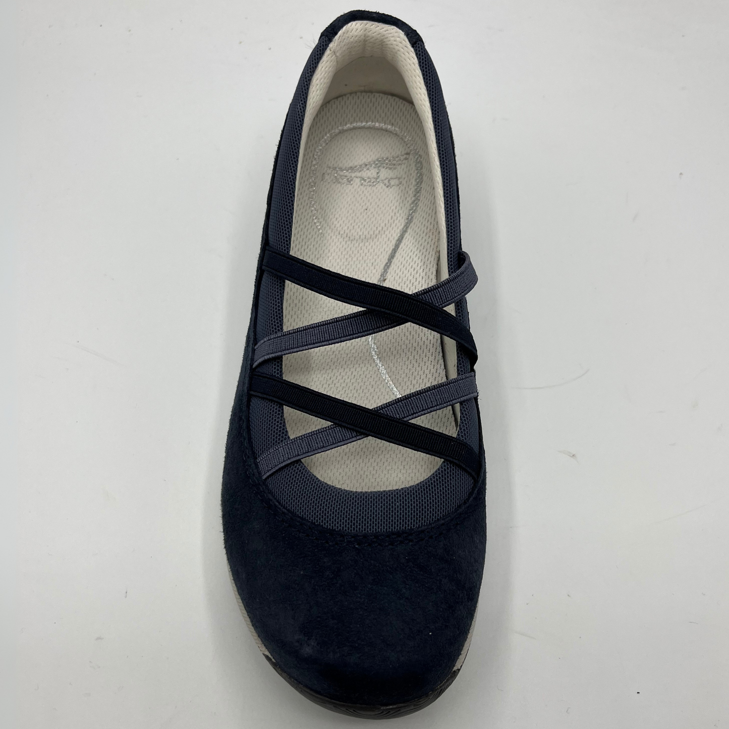 Navy blue flat shoe with criss-cross straps on a white background