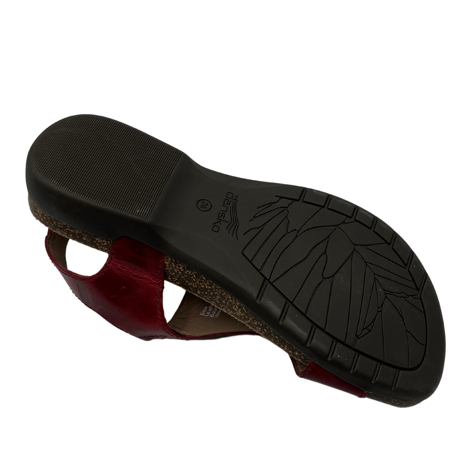 Bottom view of dark red leather sandal with velcro ankle strap and thin toe strap