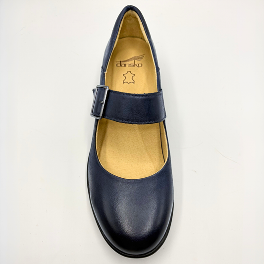 Navy blue shoe with a buckle on a light gray background