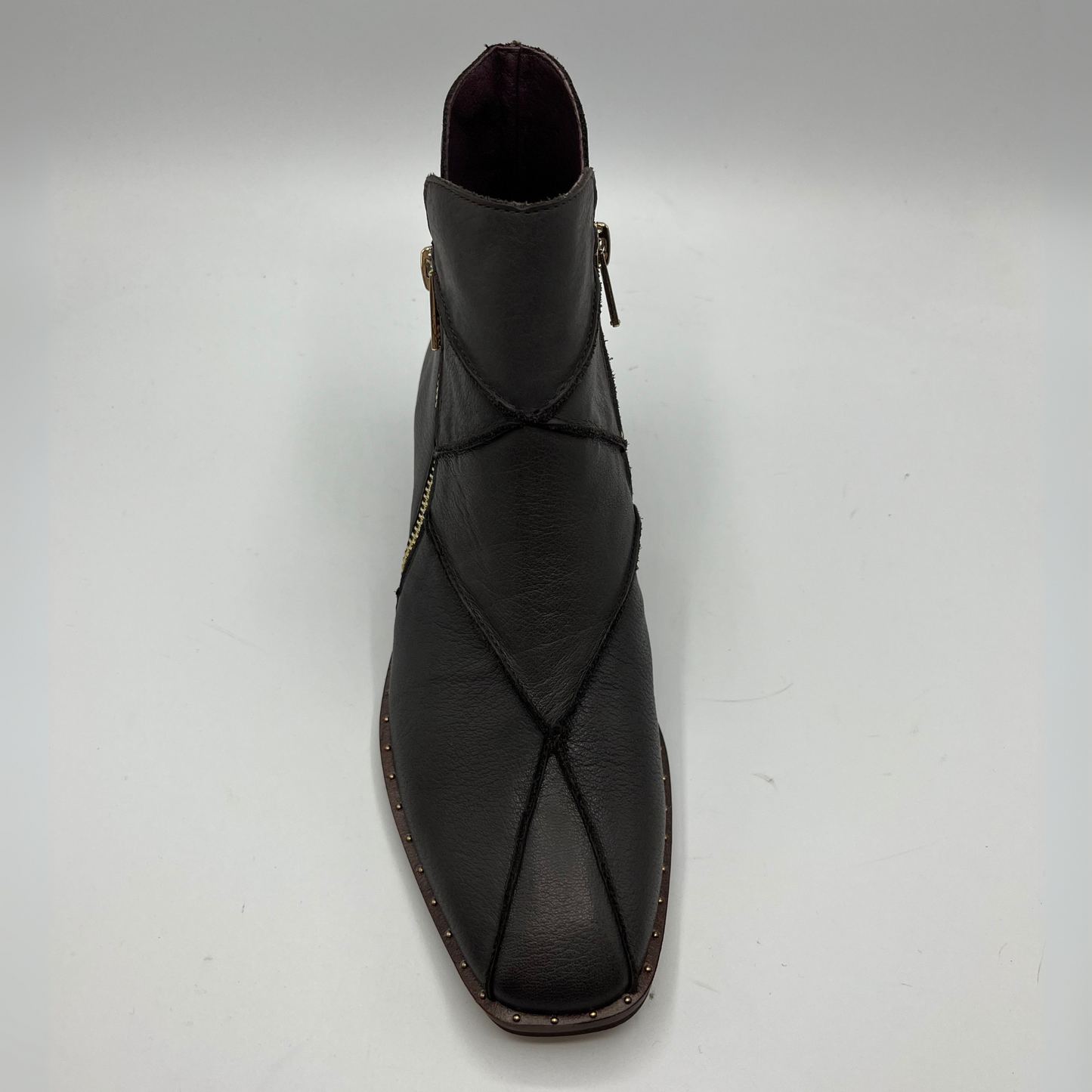 Top view of a leather ankle boot with a gold zipper