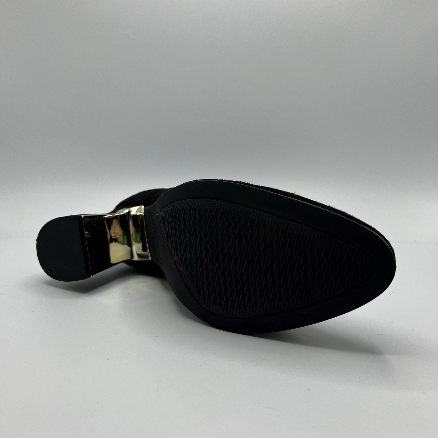 Bottom view of a black high heeled boot with shimmer detail