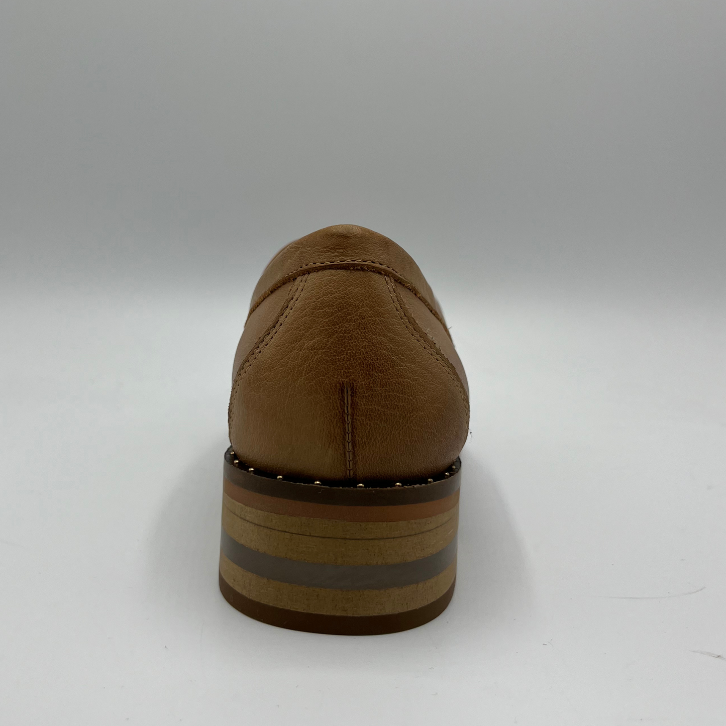 Back view of a tan leather loafer