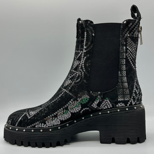 Black platform boot with sequin pattern on a gray background