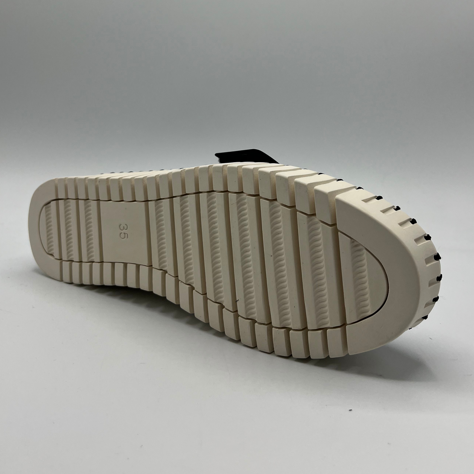 Close-up of a beige shoe sole on a gray background