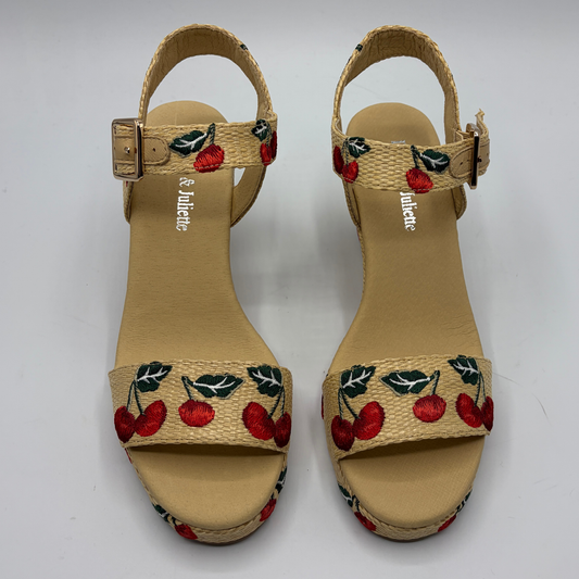 Pair of sandals with cherry design on a white background
