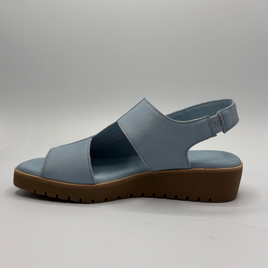 Blue sandal with a brown sole on a gray background