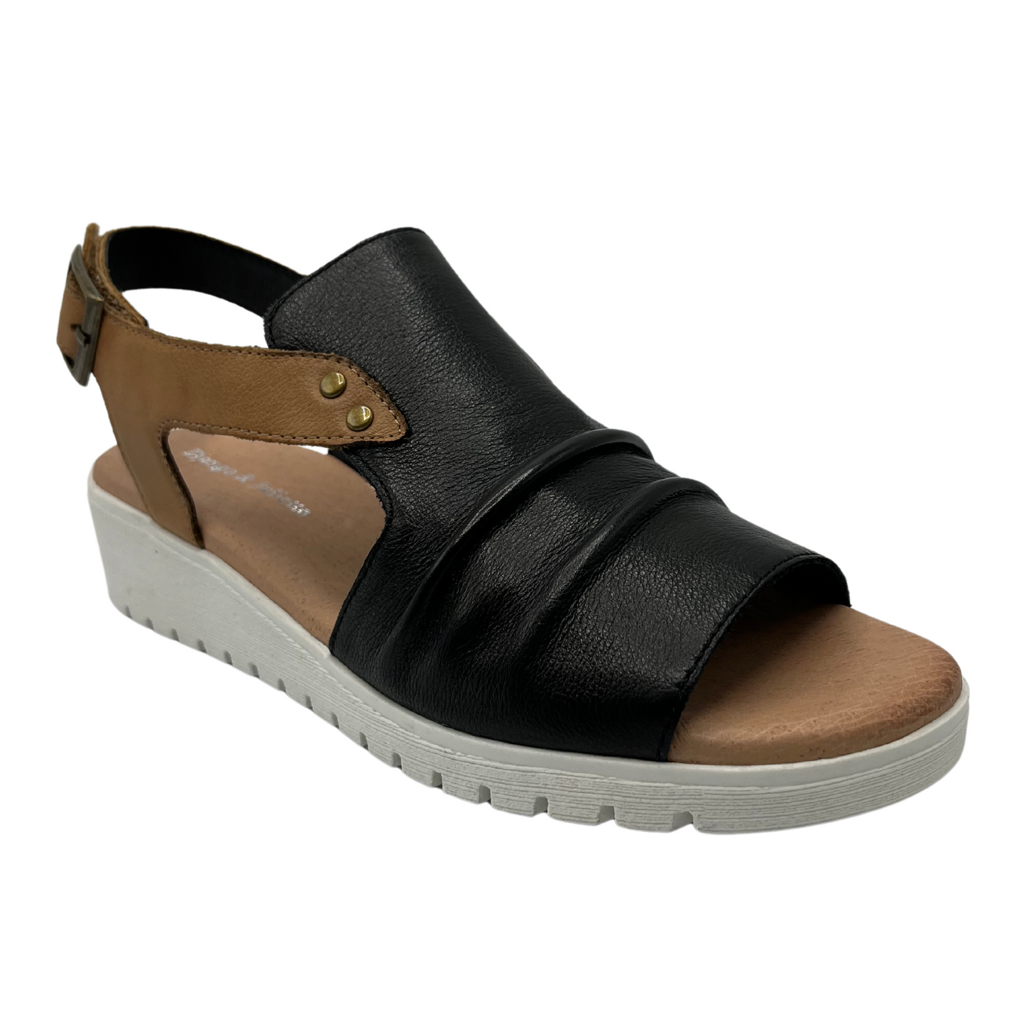 45 degree angled view of black leather sandal with low wedge heel and brown leather slingback strap
