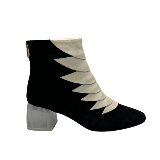 Right facing view of black and ivory short boot with translucent block heel, soft pointed toe and back zipper closure