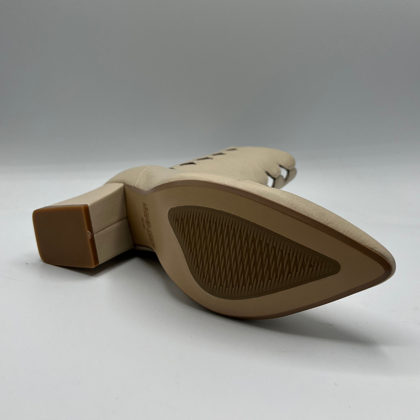 Tan shoe sole with brown heel on a white background