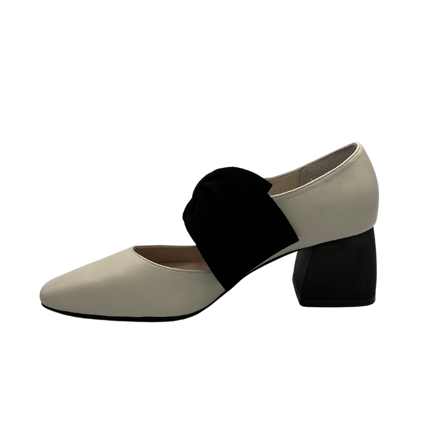 Left facing view of cream leather pump with black suede accent bow and short block heel