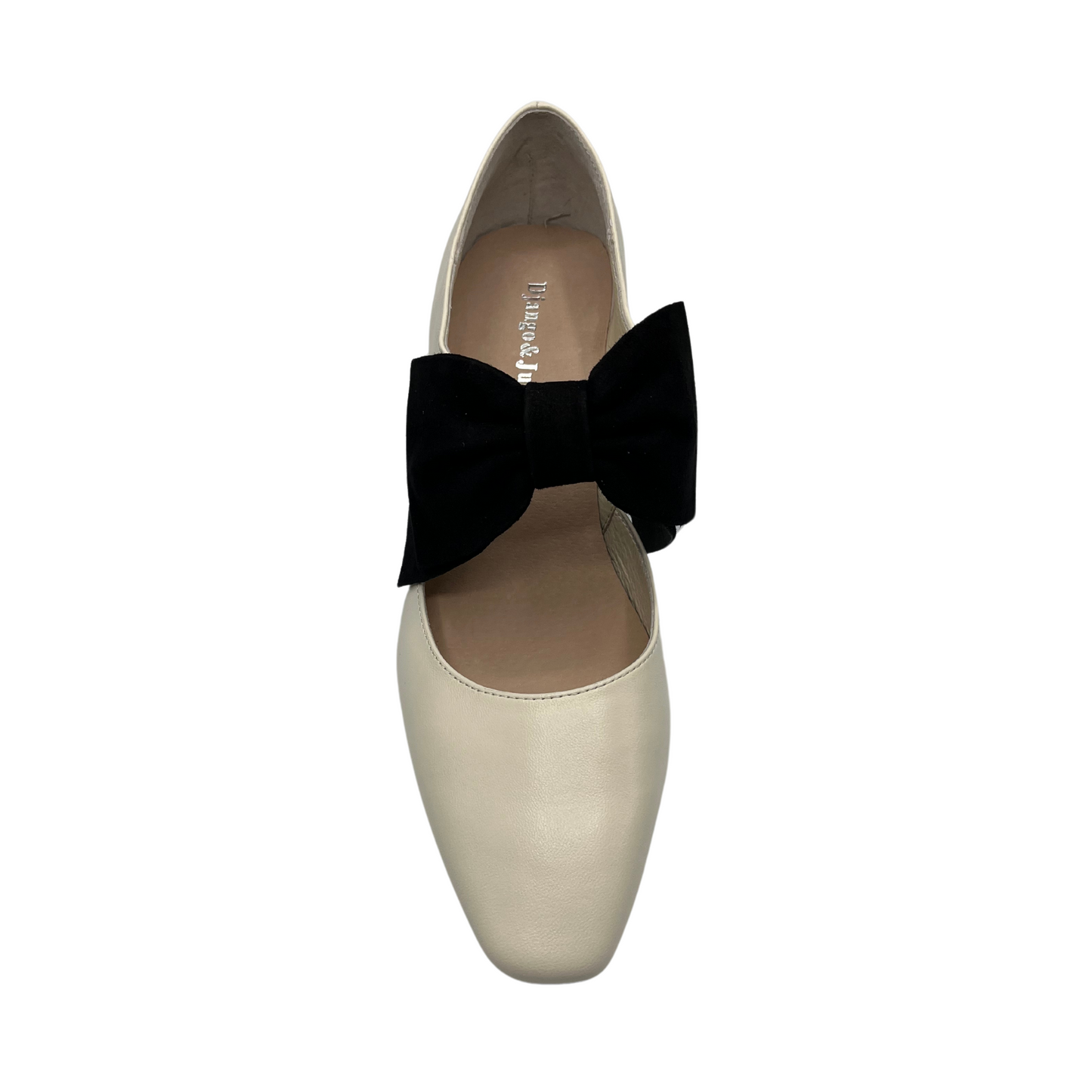 Top view of cream leather pump with black suede accent bow and short block heel
