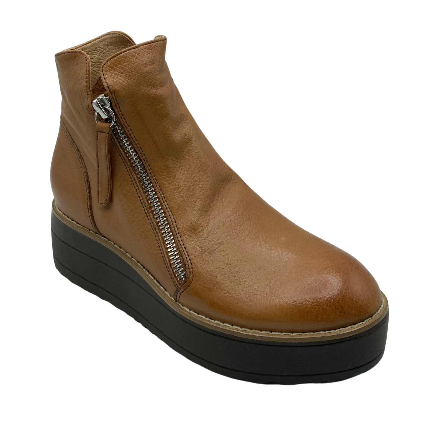 45 angled view of light brown leather boot with rounded toe and dark brown platform sole