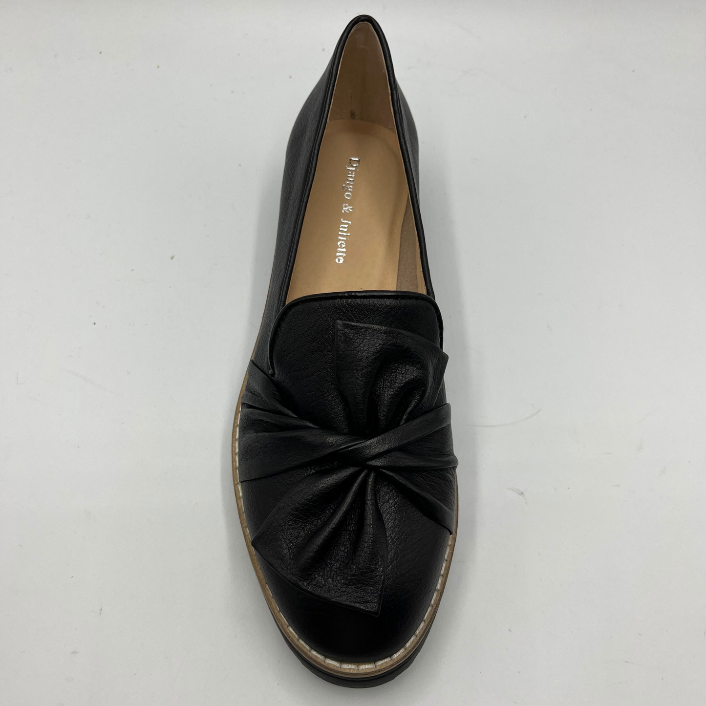 Black loafer shoe with a bow on a white background