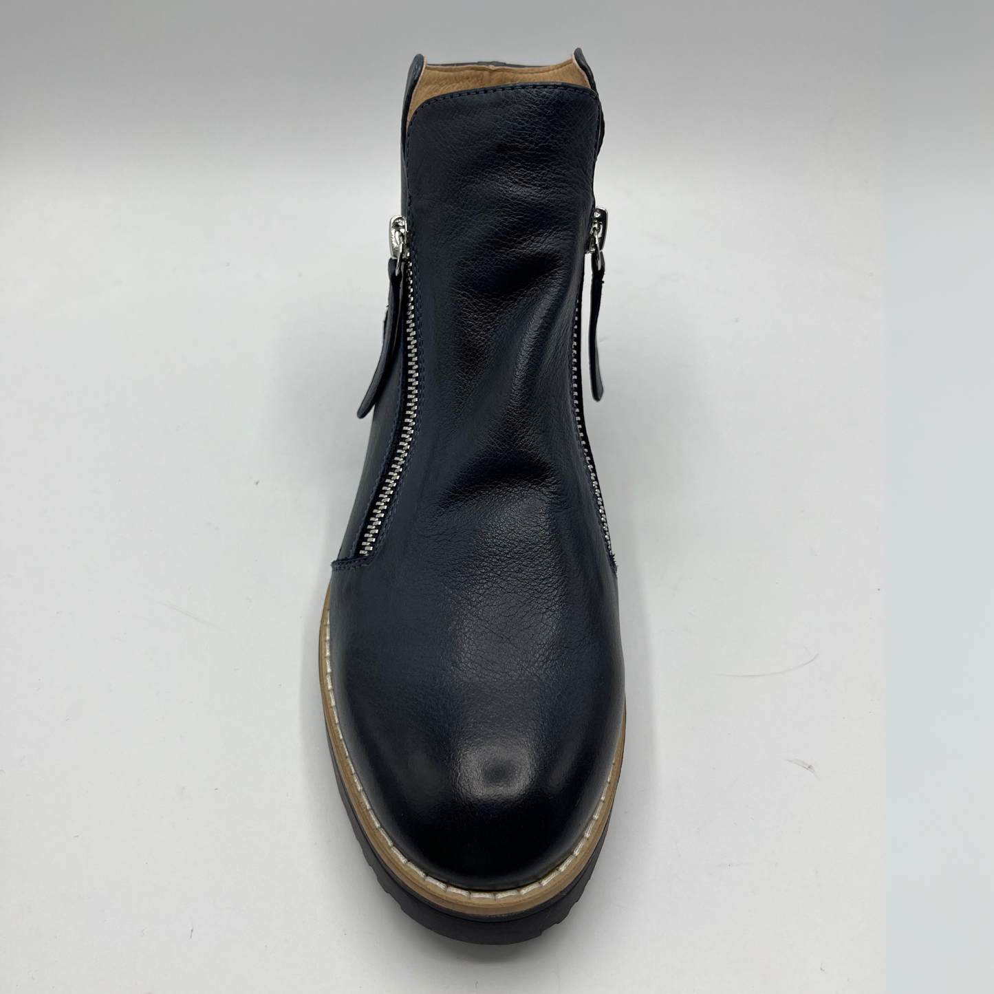 Black leather boot with a zipper on a white background
