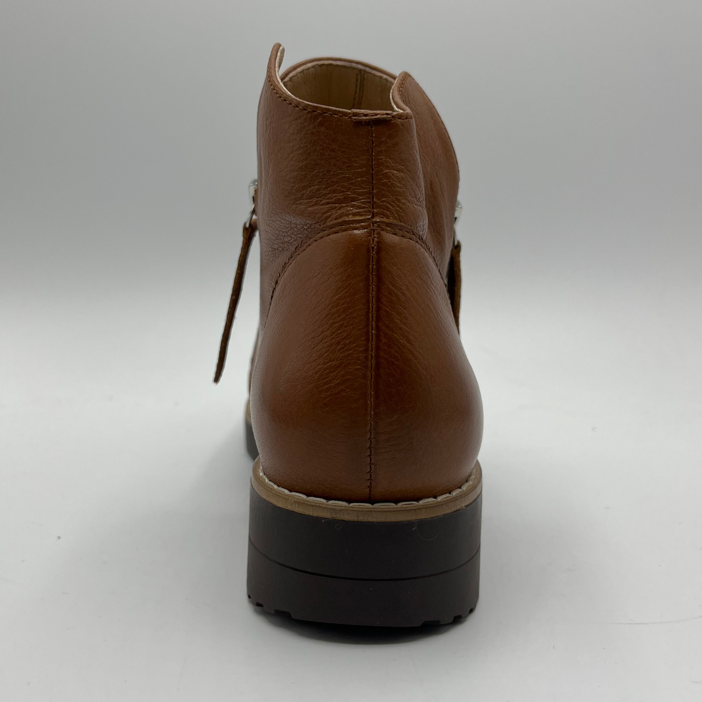 Brown leather boot on a gray background